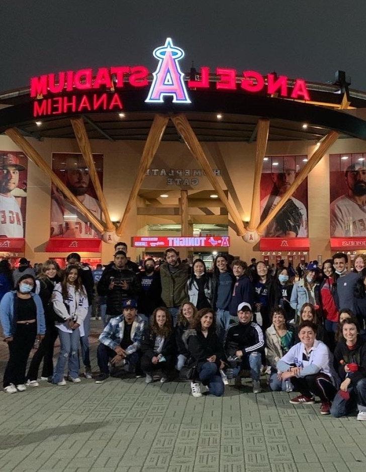 group of students standing in front of Angel stadium